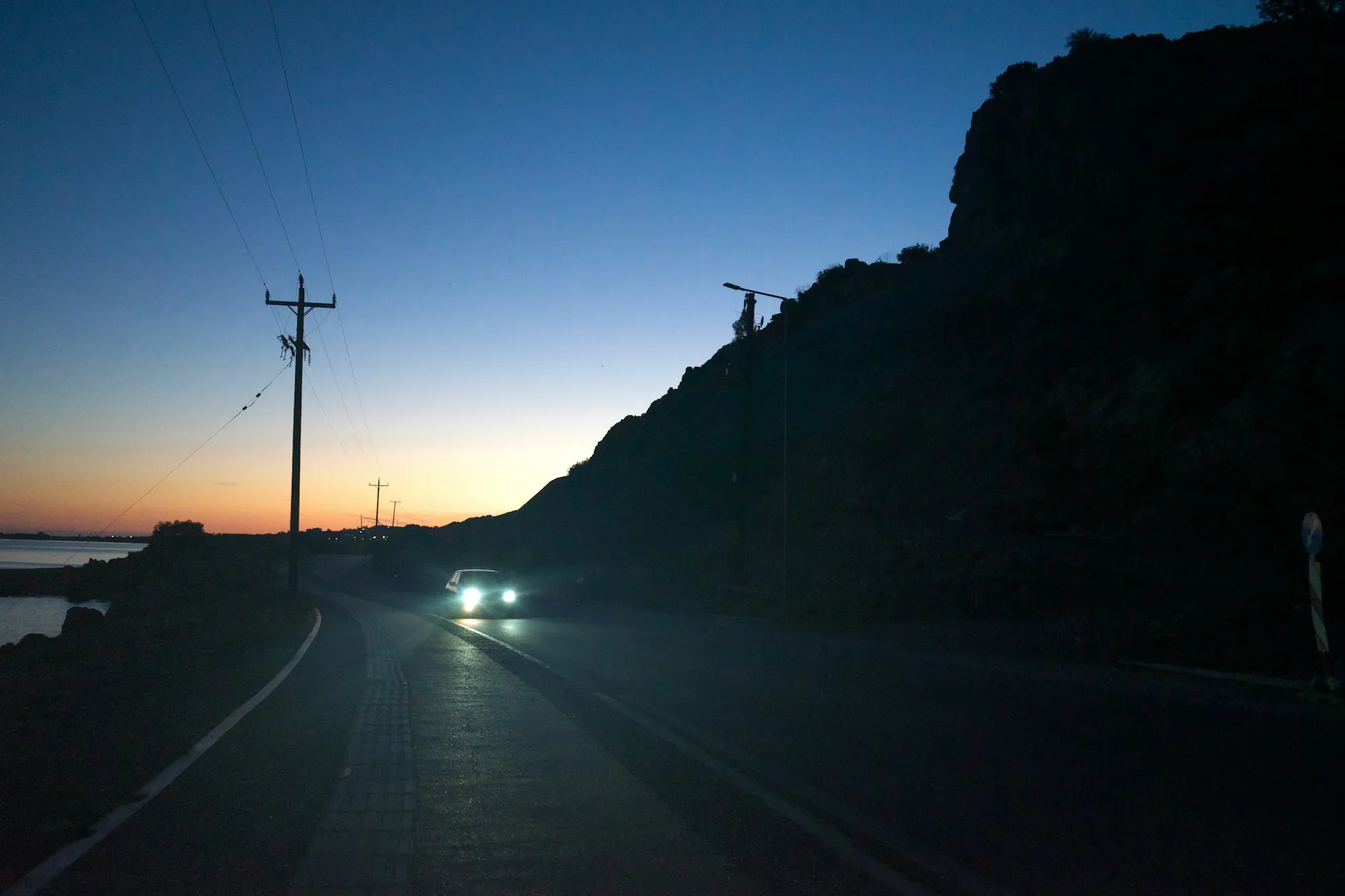 Berline sur une route de la Côte d'Azur à la tombée de la nuit